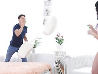 Pillow fight between lovers leads to passionate coitus